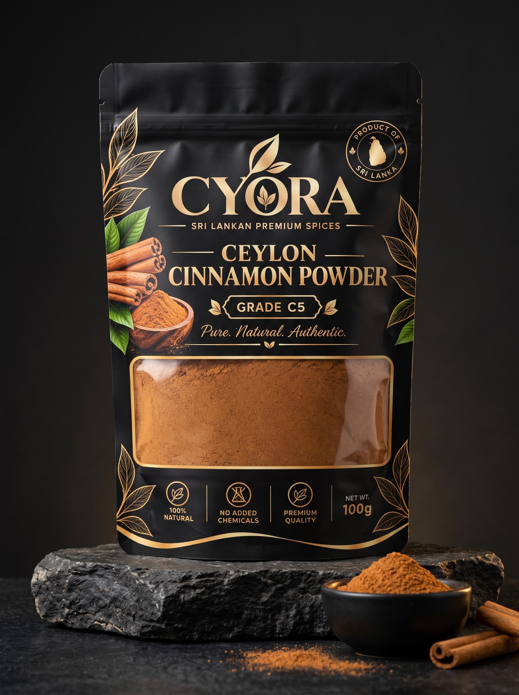 CYORA Ceylon Cinnamon Powder 100 g pouch in matte black and gold, on dark stone beside a bowl of powder