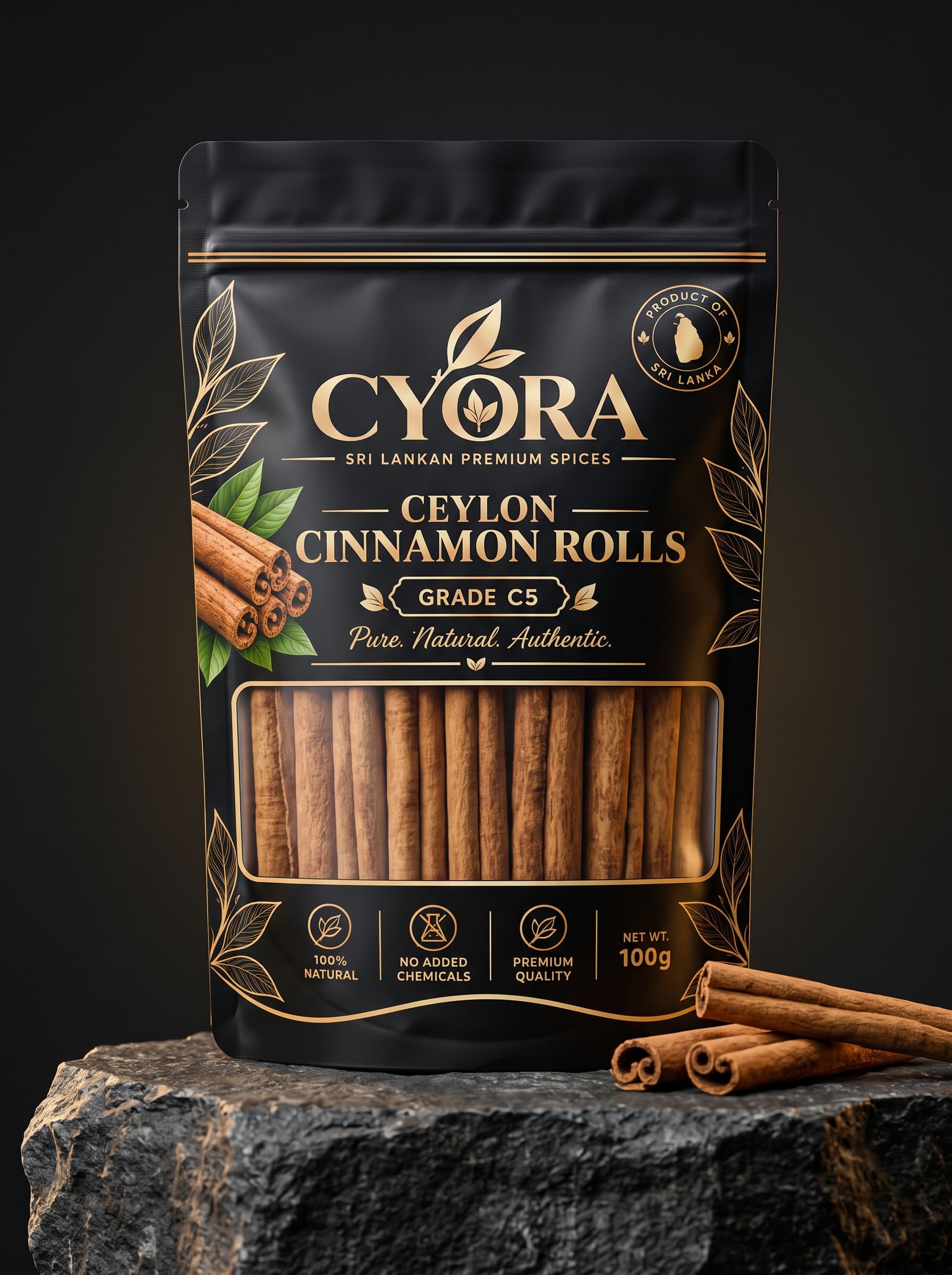 CYORA Ceylon Cinnamon Rolls 100 g pouch in matte black and gold, on dark stone beside loose quills